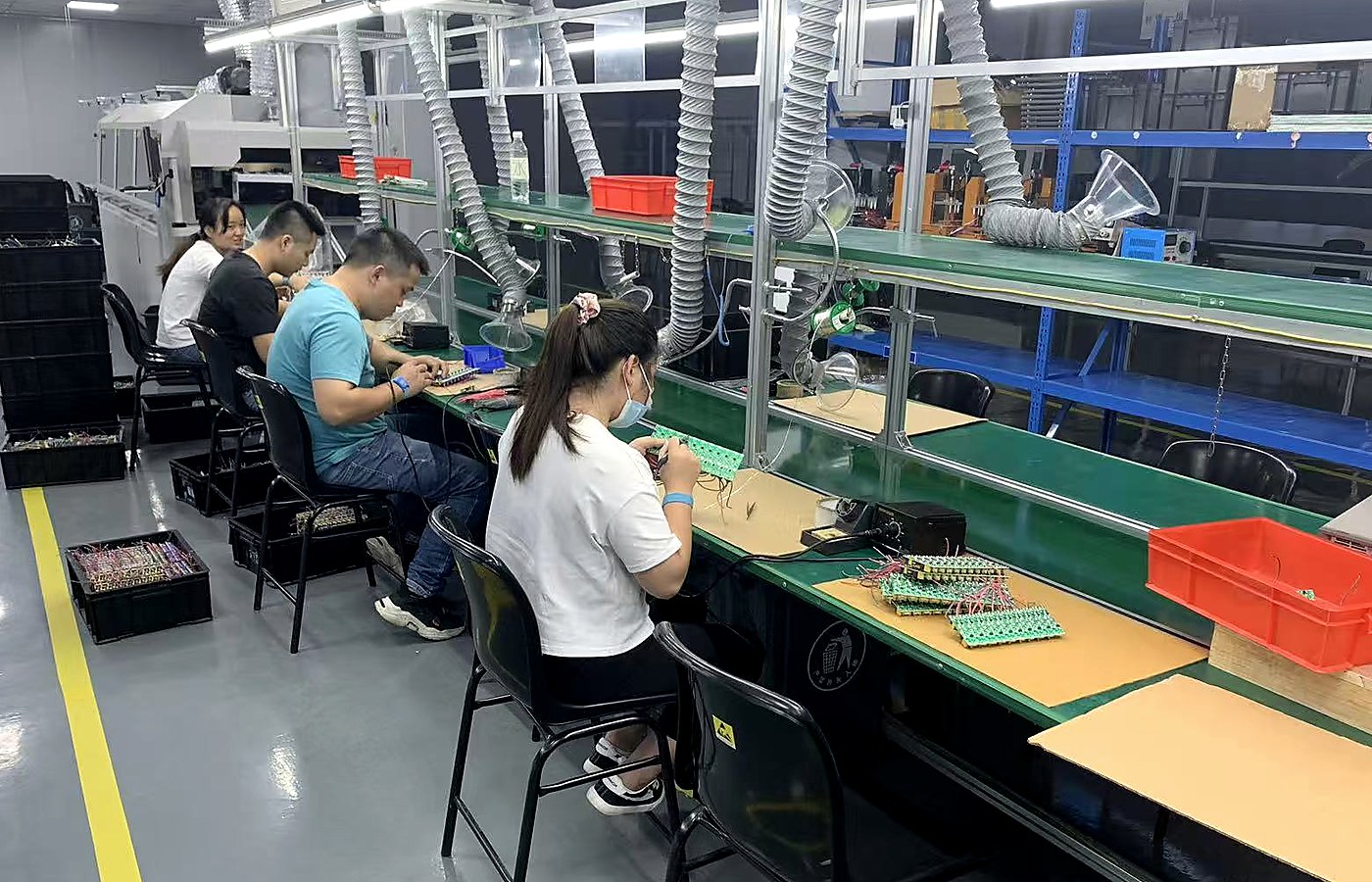 Workers inspecting and assembling LED products